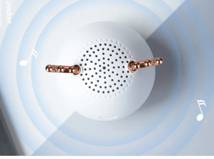 Compact portable Bluetooth speaker in green, pink or white with USB charging cable