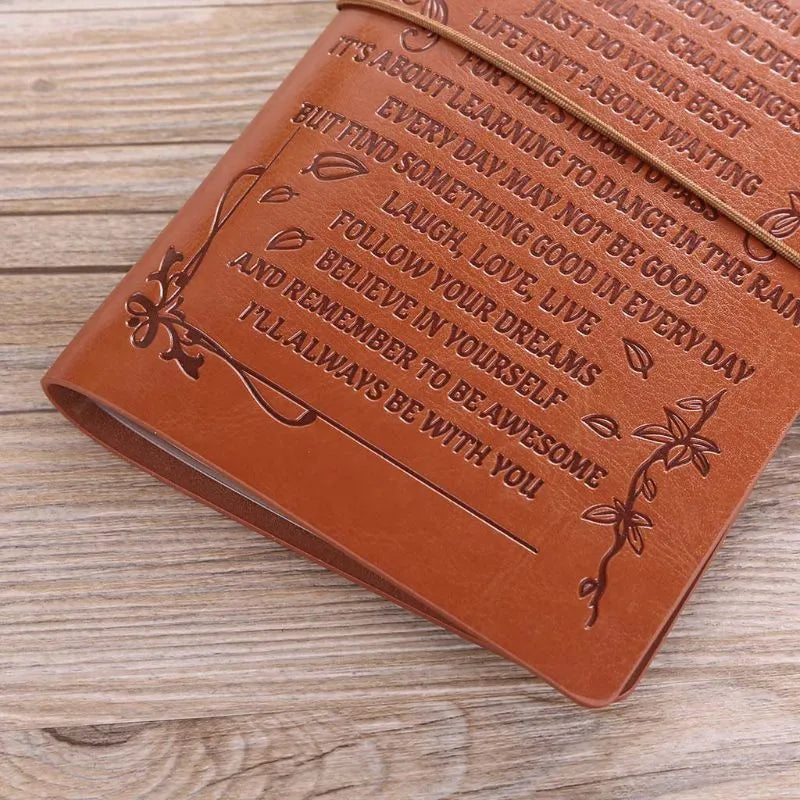 Brown leather strap-bound notebook with warm brown acid-free paper pages, shown closed.