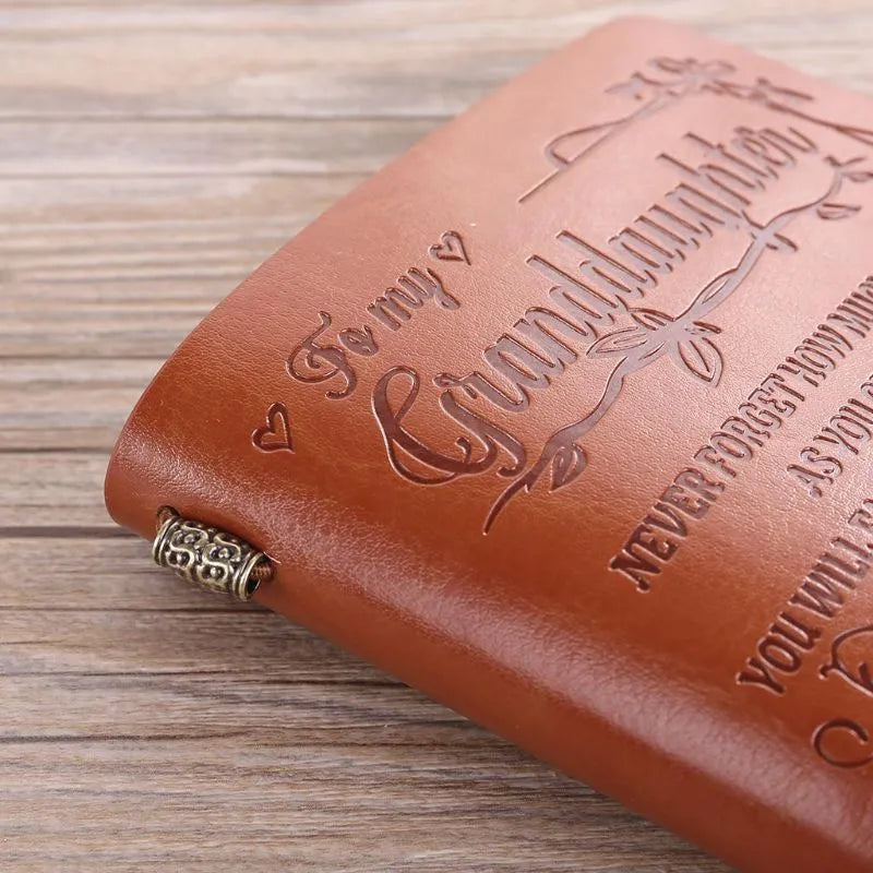 Brown leather strap-bound notebook with warm brown acid-free paper pages, shown closed.