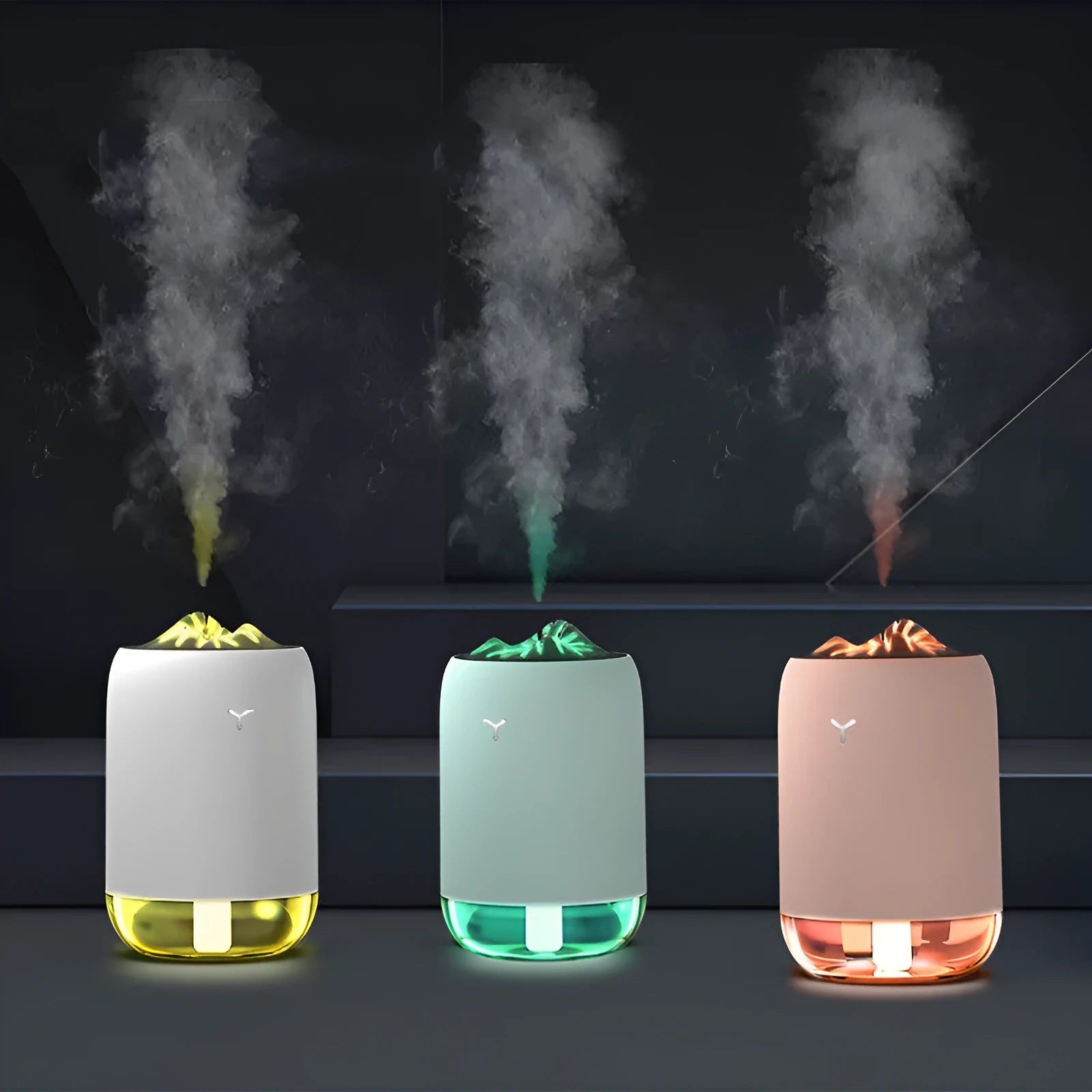 White columnar magic flame humidifier and aroma diffuser on a desktop with mist and coloured light effect.