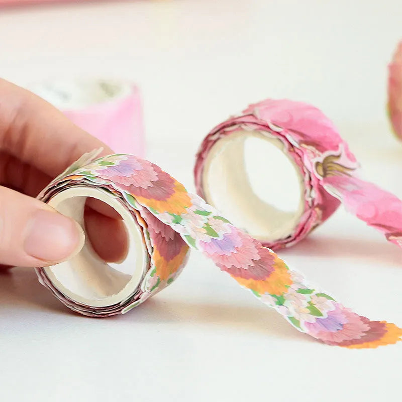 Clover and paper decorative washi tape roll showing blue, cherry blossom, violet and mixed colour patterns