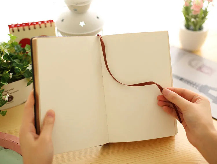 Jingu 25k thick notepad with imitation leather cover, showing large internal page size.