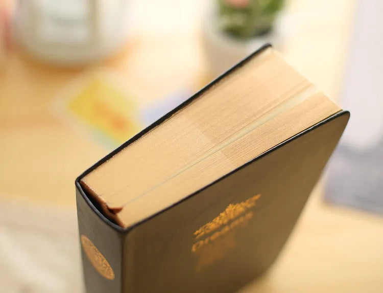 Jingu 25k thick notepad with imitation leather cover, showing large internal page size.