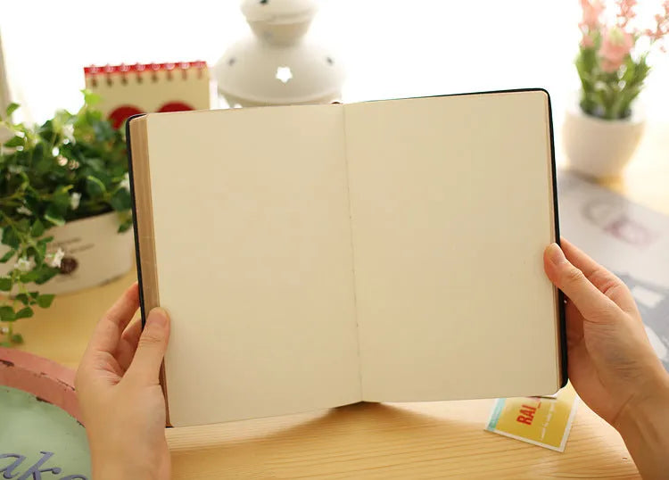 Jingu 25k thick notepad with imitation leather cover, showing large internal page size.