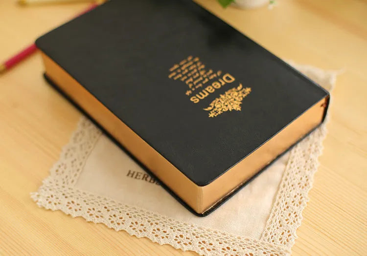 Jingu 25k thick notepad with imitation leather cover, showing large internal page size.