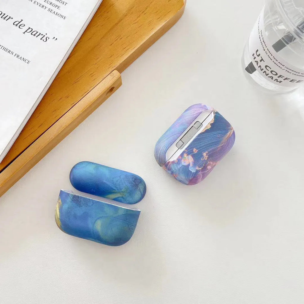 Hard plastic protective sleeve for Apple AirPods with watercolour design in pink or blue options