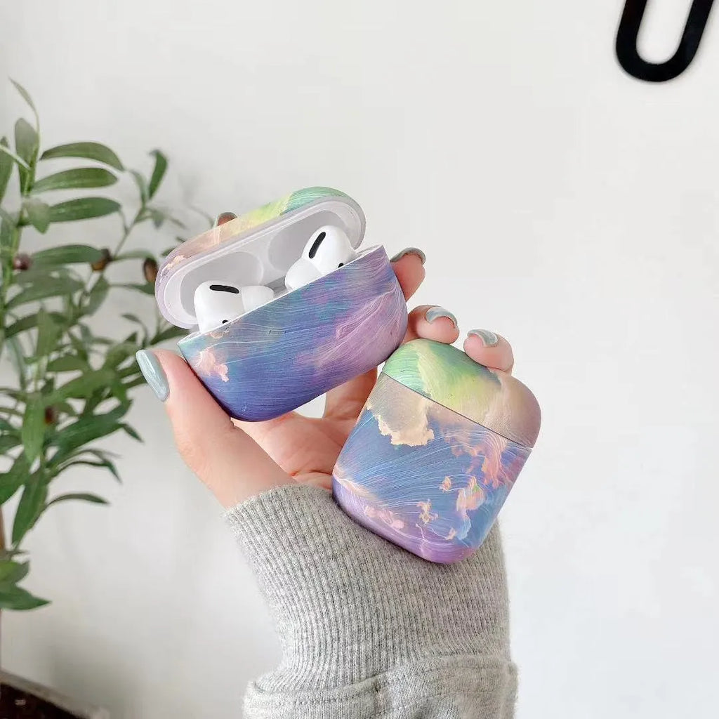 Hard plastic protective sleeve for Apple AirPods with watercolour design in pink or blue options