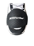 Black rubber motorcycle shift pad with anti-slip silicone and adjustable hook and loop fastening on a boot.