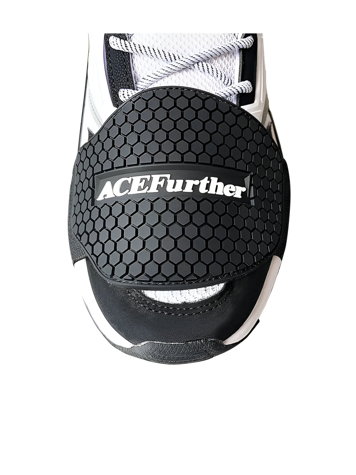 Black rubber motorcycle shift pad with anti-slip silicone and adjustable hook and loop fastening on a boot.