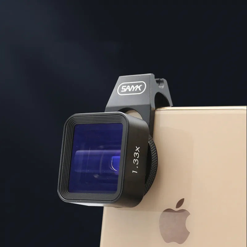 Black SANYK 1.33x anamorphic widescreen lens attached to smartphone for cinematic video recording