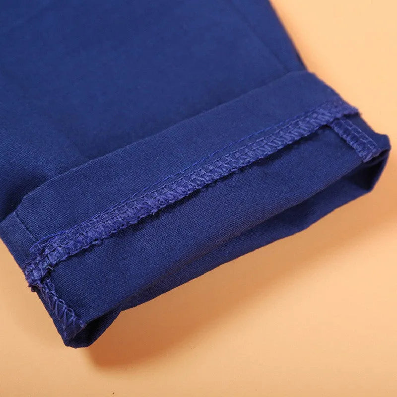 Blue boys' three-piece suit set with turtleneck, vest, trousers, and tie on a hanger.