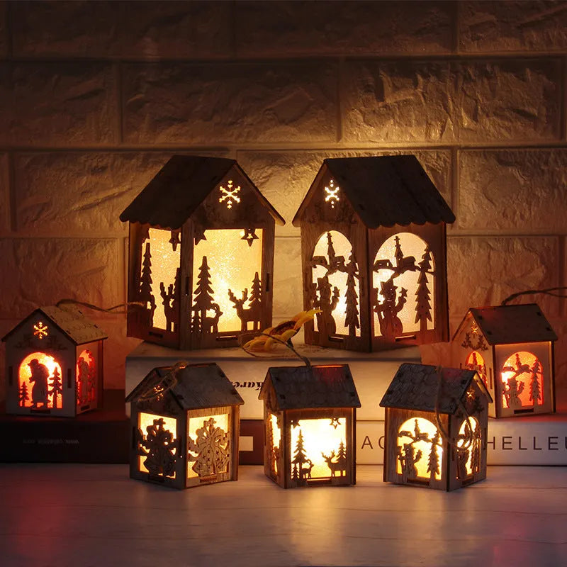 Three wooden Christmas house decorations showing log bell, old man house, and snowman house styles in natural wood colour
