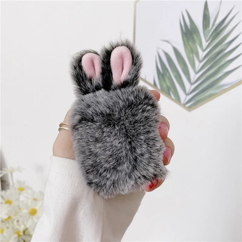 Pink silicone protective cover with rabbit ears for Apple AirPods charging case.