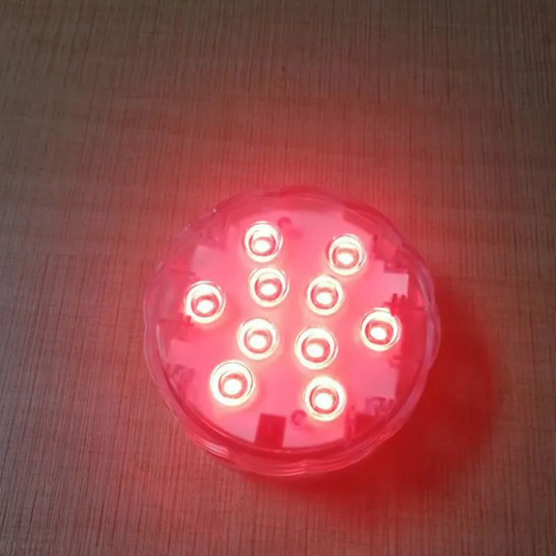 Round white remote control waterproof LED light with colour-changing LEDs for garden and pool decoration.