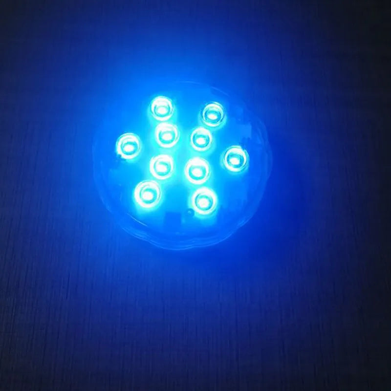 Round white remote control waterproof LED light with colour-changing LEDs for garden and pool decoration.