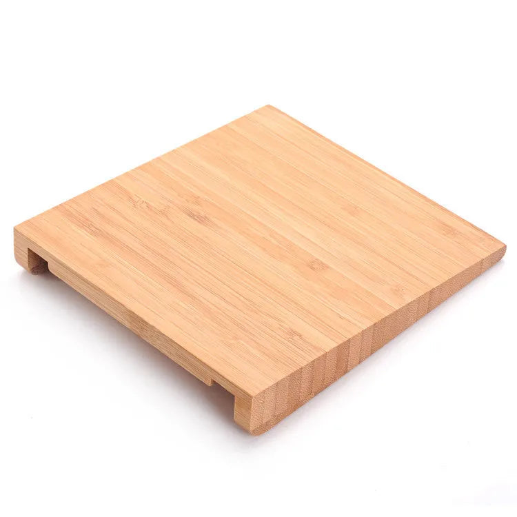 Bamboo wood Apple Bluetooth tablet bracket on a desk next to a trackpad.