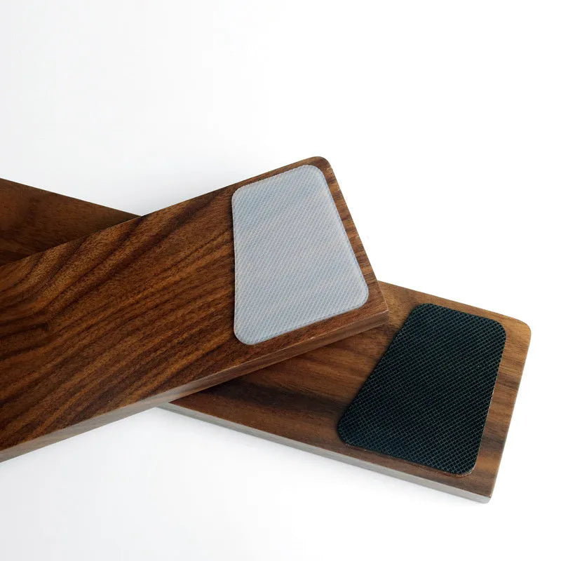 Solid walnut wood keyboard wrist rest with natural grain on a desk