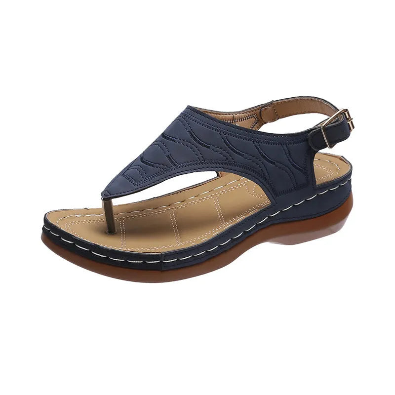 Women's casual wedge heel flip flop sandals with an adjustable buckle strap on the back, shown in a solid colour.