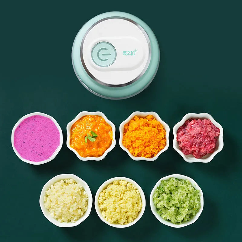 Portable electric mini food chopper with transparent cup and stainless steel blade on a kitchen counter