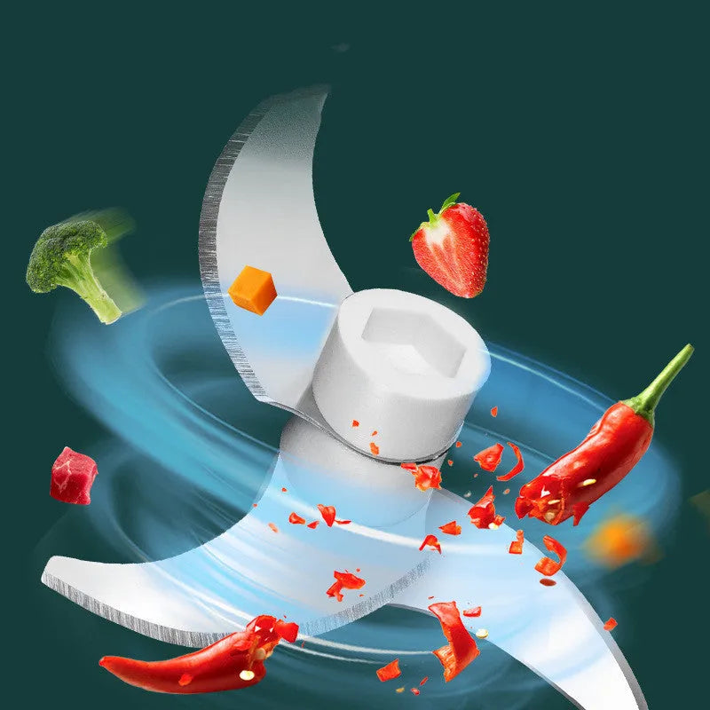 Portable electric mini food chopper with transparent cup and stainless steel blade on a kitchen counter