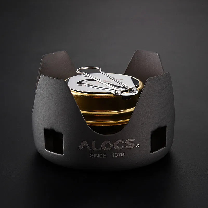 Alocs one-piece alcohol stove for outdoor use, shown with optional 0.8L or 1.4L kettle set and handle options