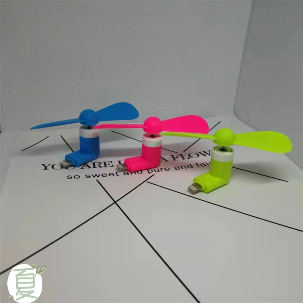 White portable mini fan with plastic blades and a rotary switch for mobile phones.