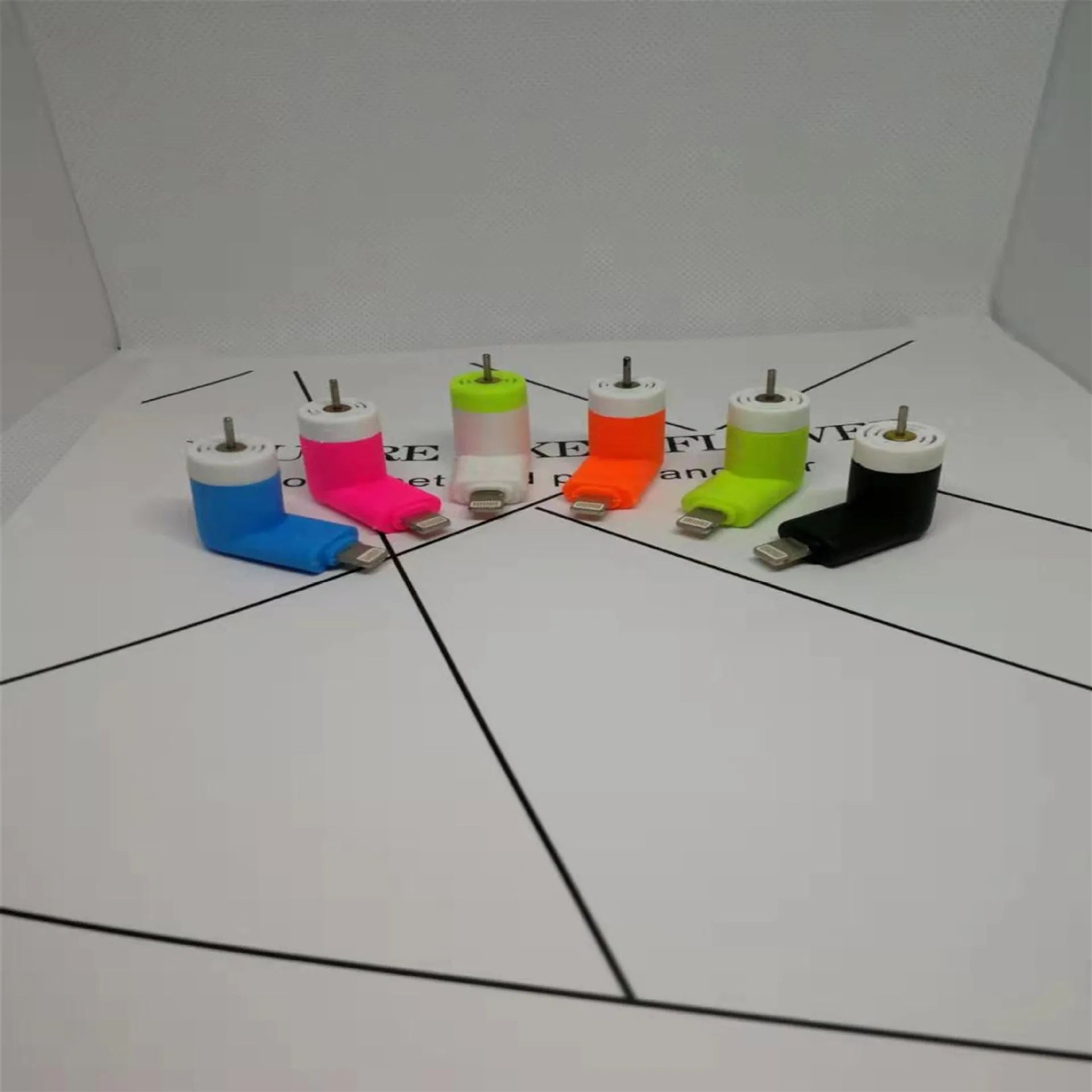 White portable mini fan with plastic blades and a rotary switch for mobile phones.