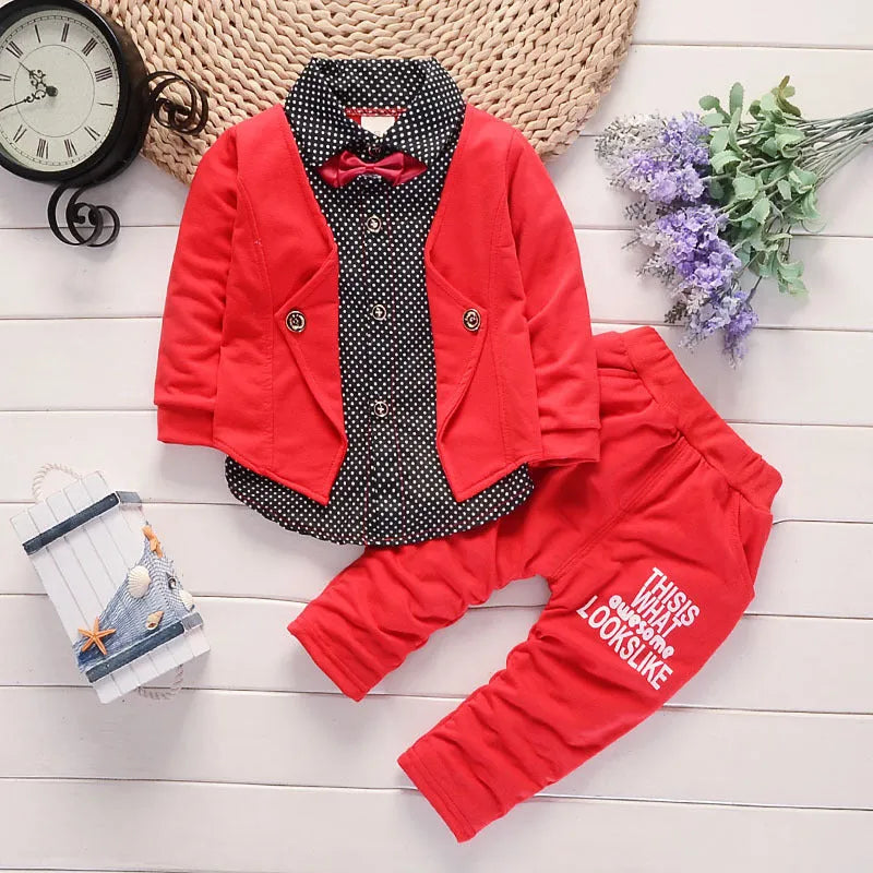 Toddler boy wearing a grey casual printed jacket and matching trousers suit set
