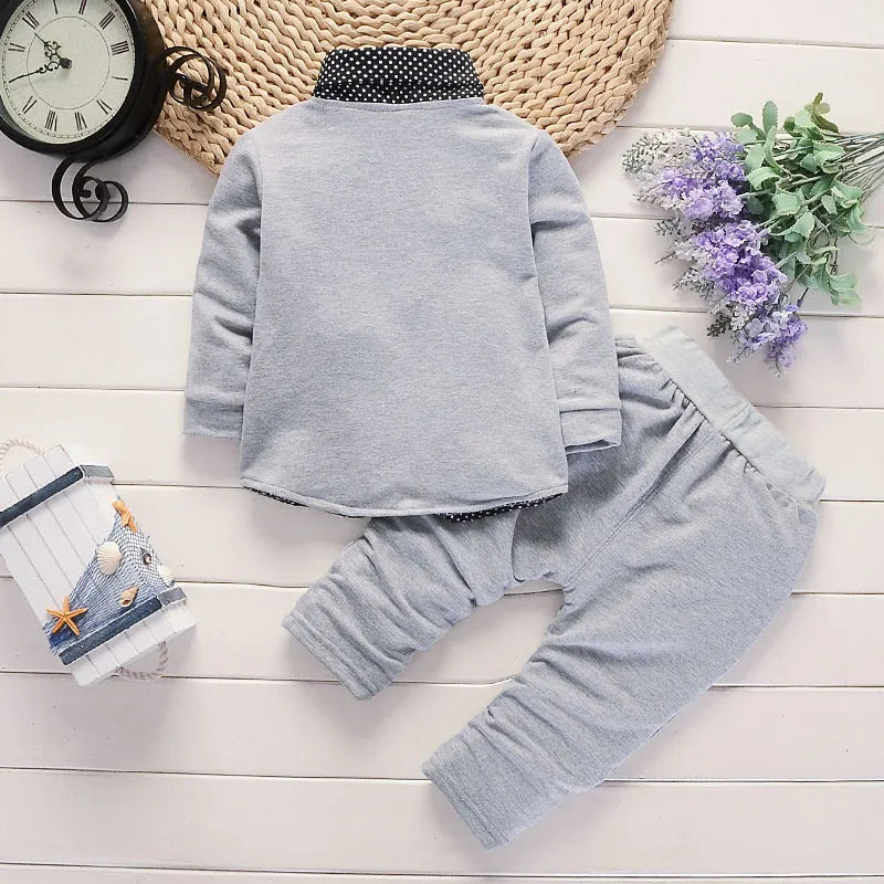 Toddler boy wearing a grey casual printed jacket and matching trousers suit set
