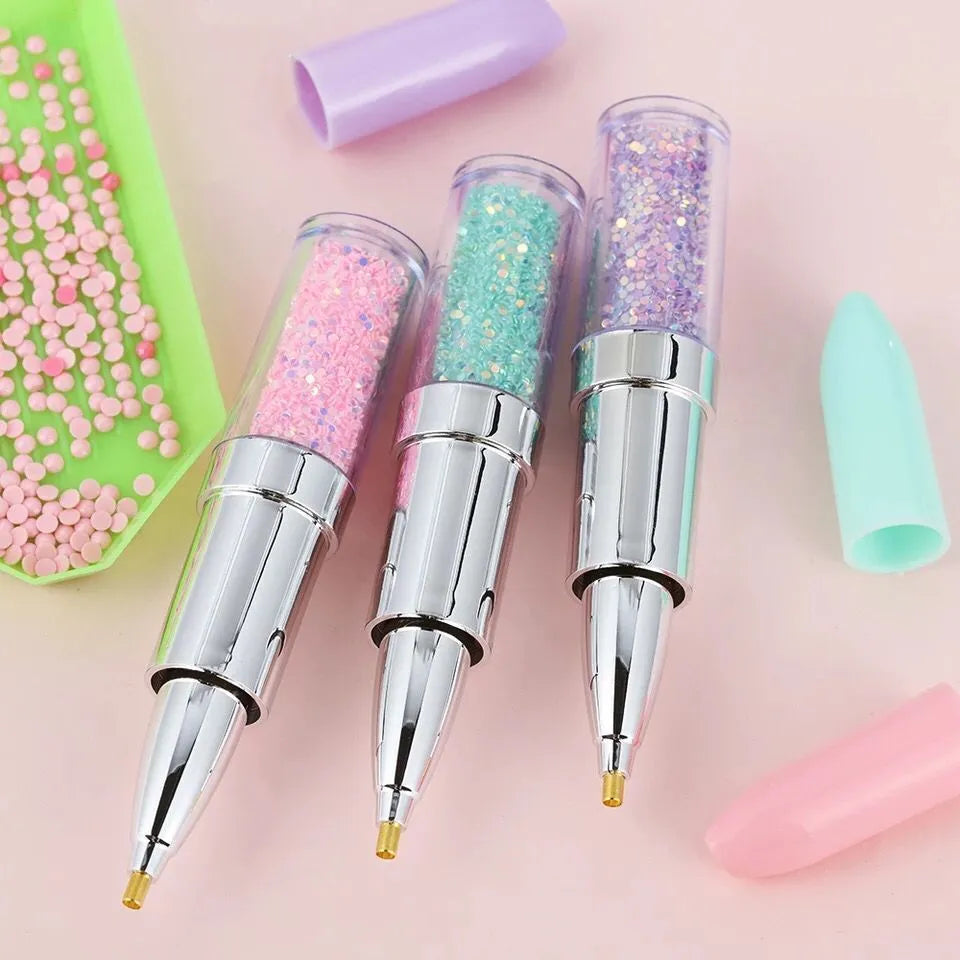 Plastic luminous point drill pen for diamond painting in green, pink, or purple colour options.