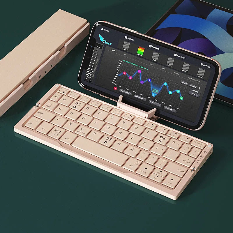 Silver white folding Bluetooth keyboard shown open with stand holding a smartphone, and folded next to a ruler for scale.