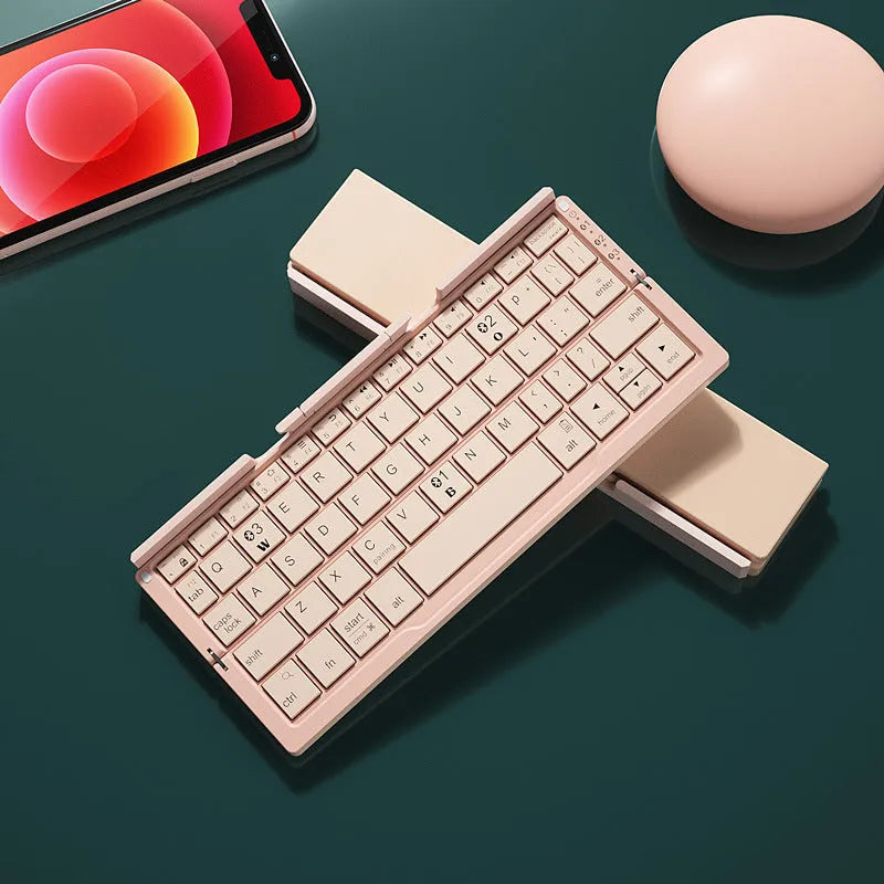 Silver white folding Bluetooth keyboard shown open with stand holding a smartphone, and folded next to a ruler for scale.