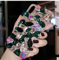 Clear rhinestone crystal decorative phone case for iPhone on a table.