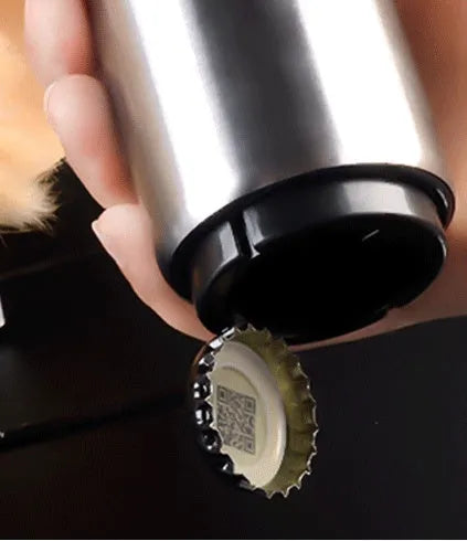 Stainless steel automatic beer bottle opener in assorted colours on a wooden surface.