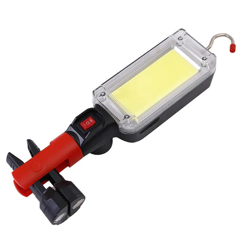 Portable COB LED work light with magnet hook, showing 700 lumens brightness and USB charging port for camping and maintenance tasks.