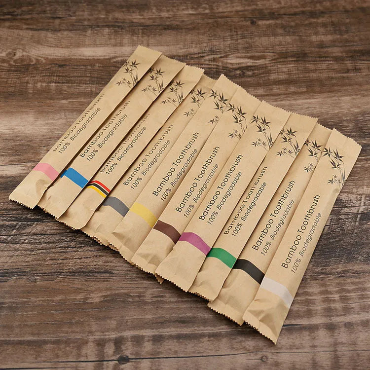 Set of 10 bamboo toothbrushes with charcoal bristles in various colours showing 17.5cm handles