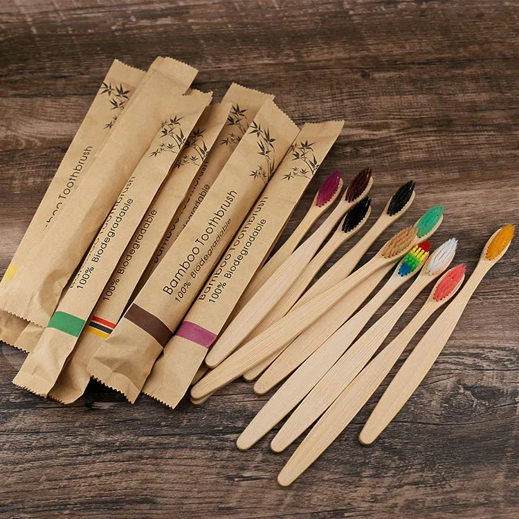 Set of 10 bamboo toothbrushes with charcoal bristles in various colours showing 17.5cm handles