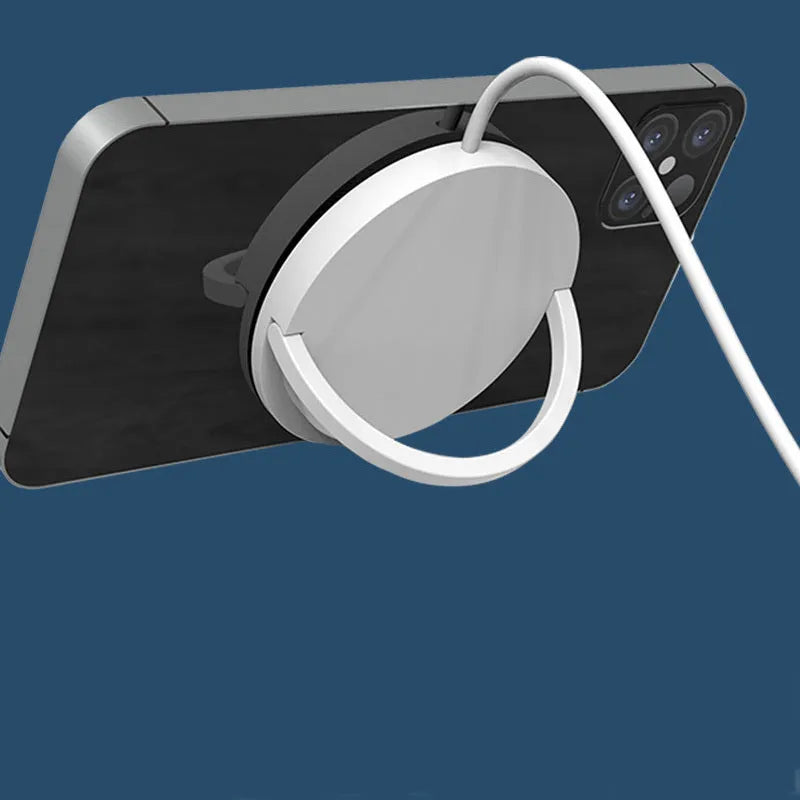 Black magnetic wireless phone charger with a mobile phone attached, showing the TYPE-C port on the side.