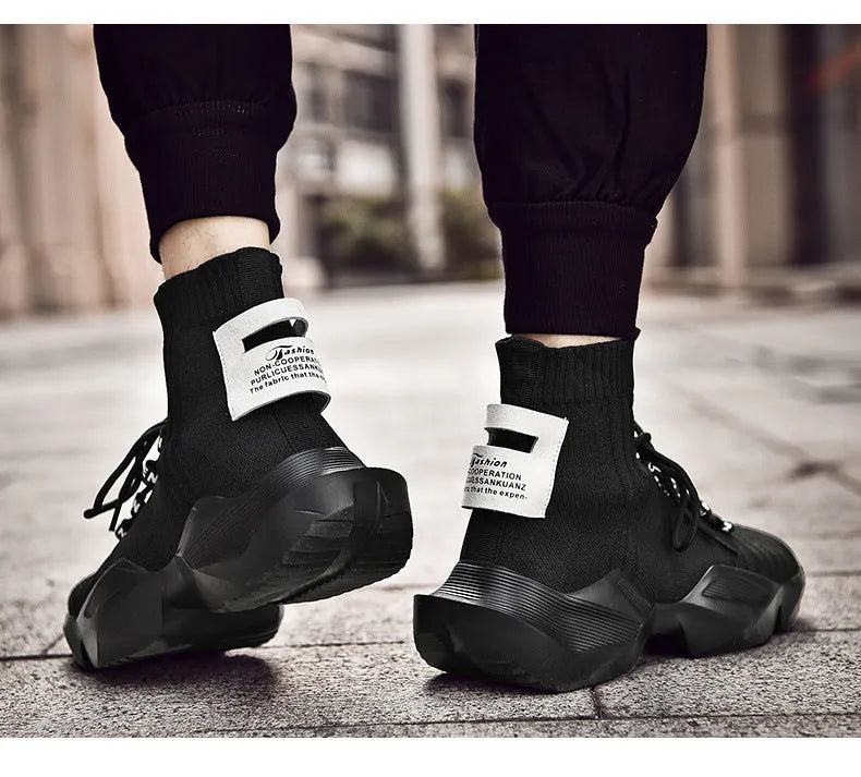 Men's black and white casual sports shoes with mesh lining and thick sole.