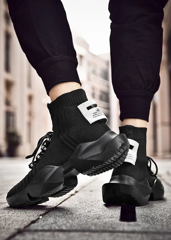 Men's black and white casual sports shoes with mesh lining and thick sole.