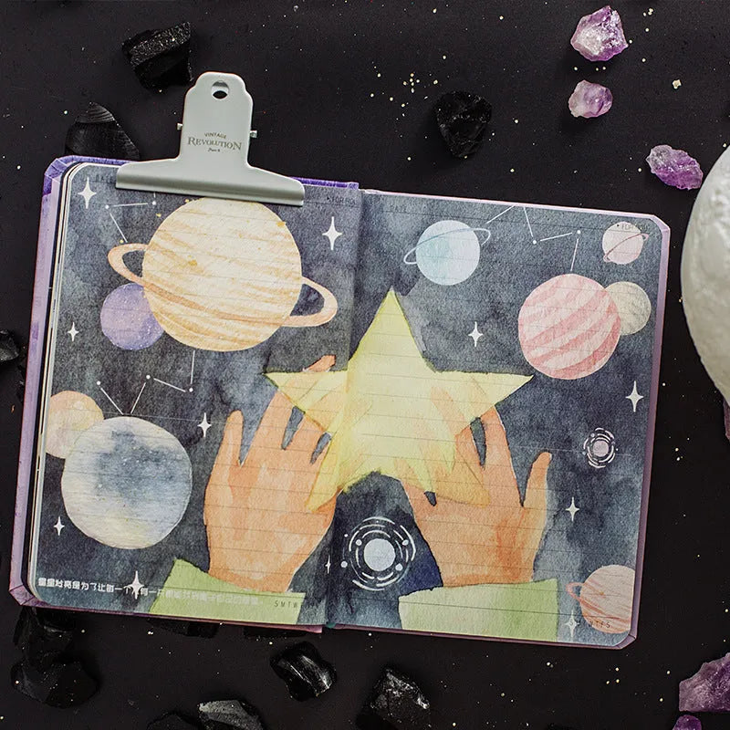 A5 hardback notebook with The Little Prince cartoon illustration cover, open on a flat surface.