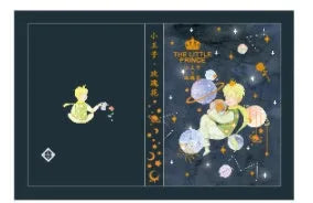 A5 hardback notebook with The Little Prince cartoon illustration cover, open on a flat surface.