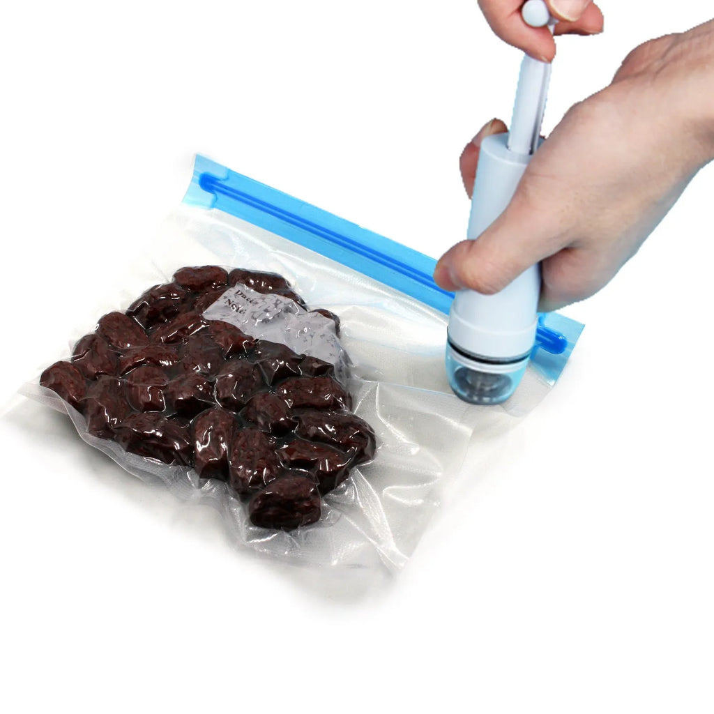 Green and grey manual vacuum compression storage bag with a manual hand pump.