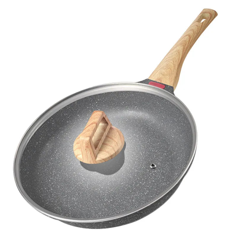 Green Korean-style macadamite non-stick frying pan with double bottom on hob