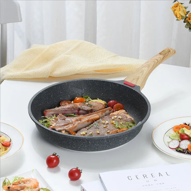 Green Korean-style macadamite non-stick frying pan with double bottom on hob