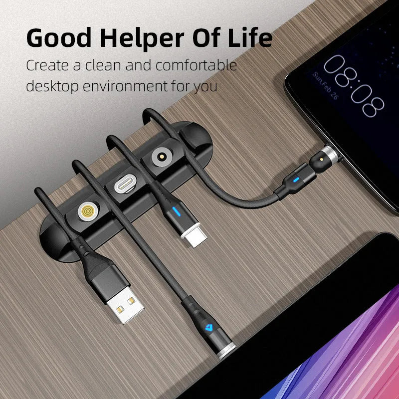 Black soft plastic desktop magnetic data cable organiser on a desk