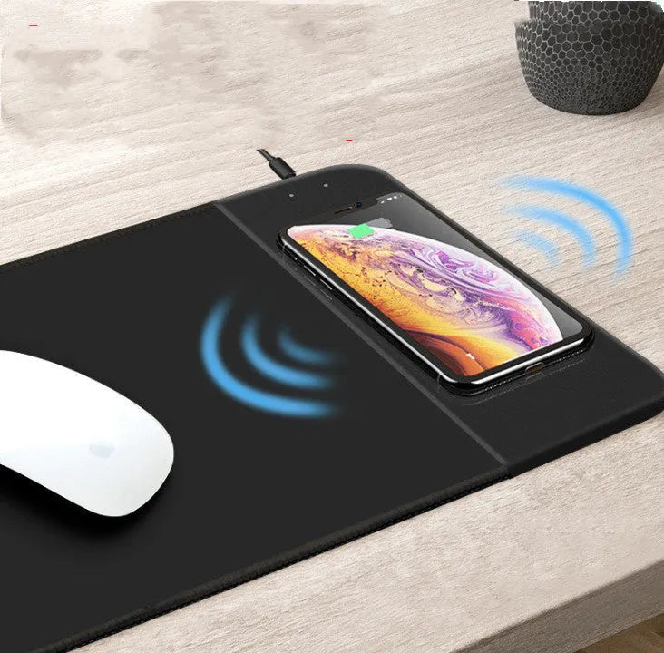 Wireless charging mouse pad with cartoon design, RGB lighting, and 298mm x 215mm dimensions on desk
