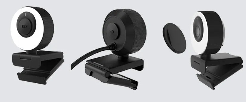 Black USB computer camera with 1080p resolution, built-in microphone, and magnetic privacy cover on a desktop