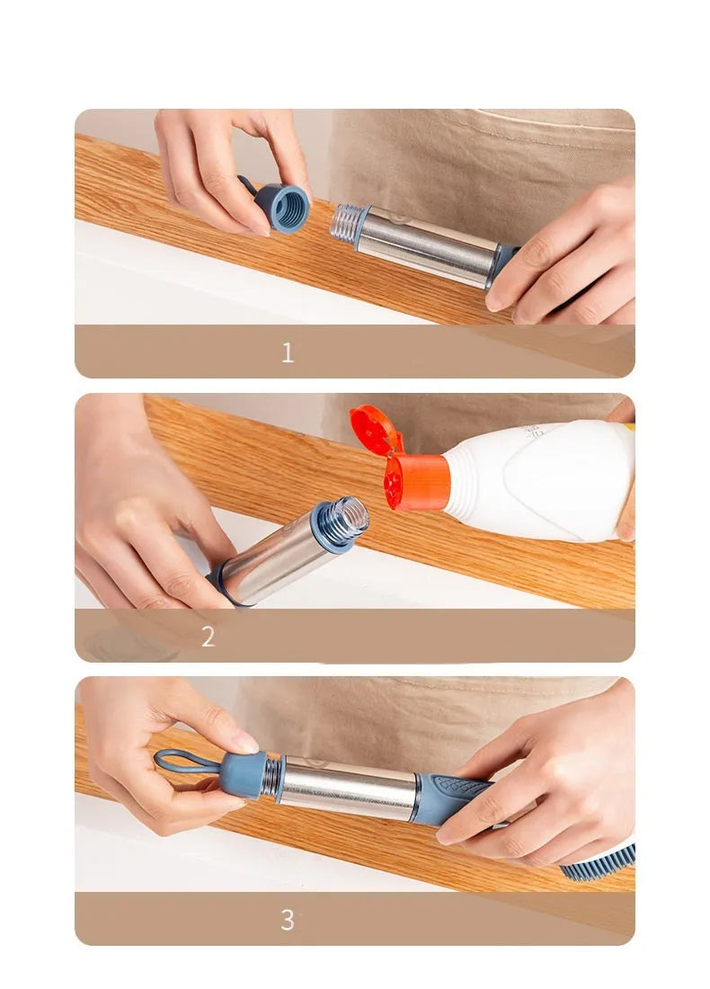 Long handled kitchen cleaning brush with a soap dispenser button and a stainless steel scouring block.