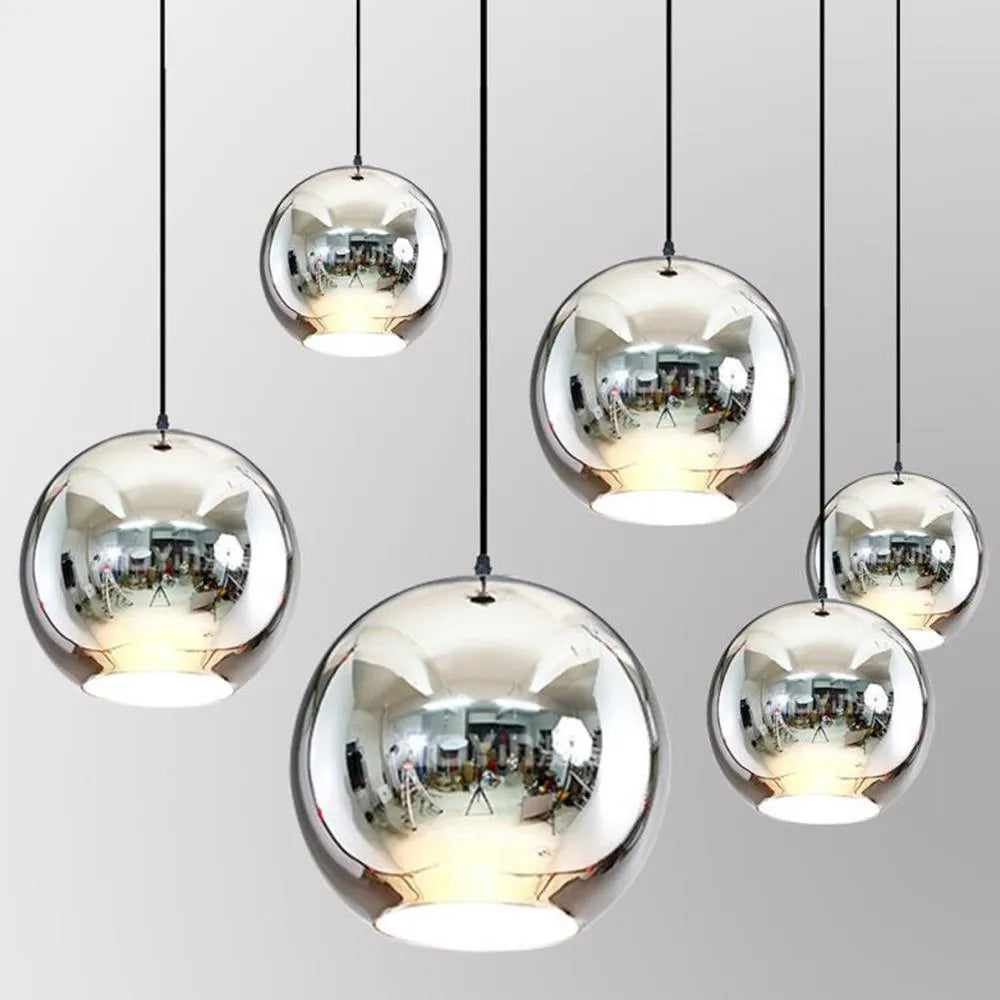 Single head round glass chandelier with iron frame and adjustable cable in a gold finish.